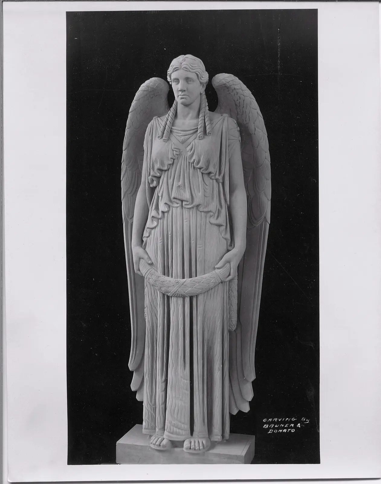 Winged figure before installation