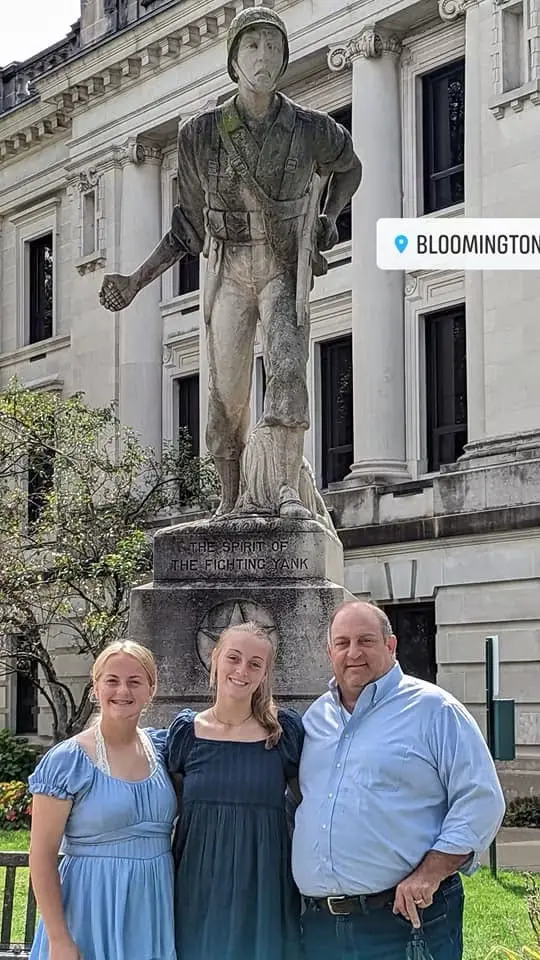 Albert M. Donato III with his daughters Nicole and Tori in front of The Spirit of the Fighting Yank in Bloomington